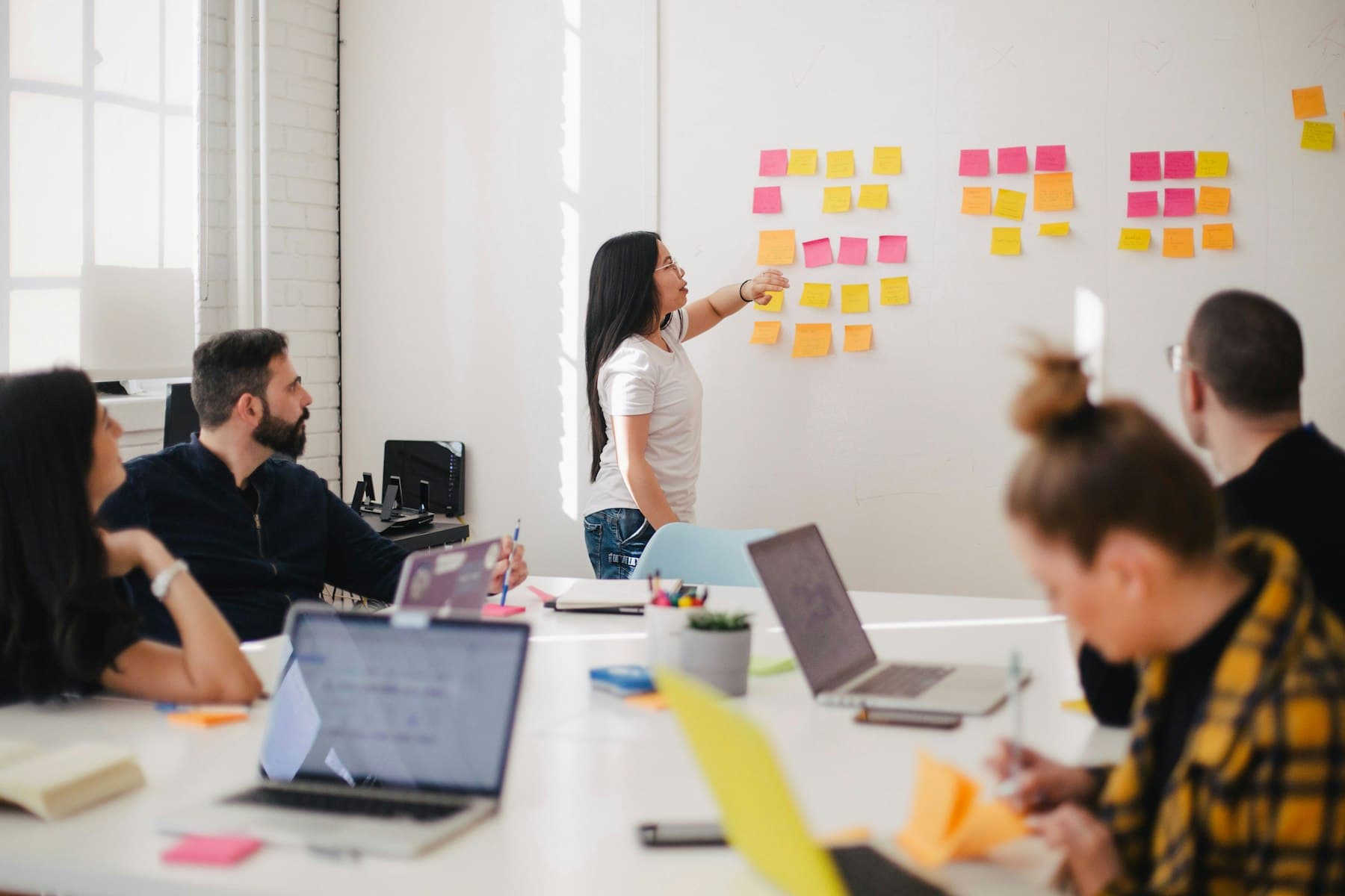 Executive advisory conversation in a bright meeting room.